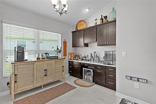 924 Figwood Loop, The Villages, FL 32163 - kitchen with dark brown cabinets, wine cooler, a chandelier, light countertops, and lofted ceiling