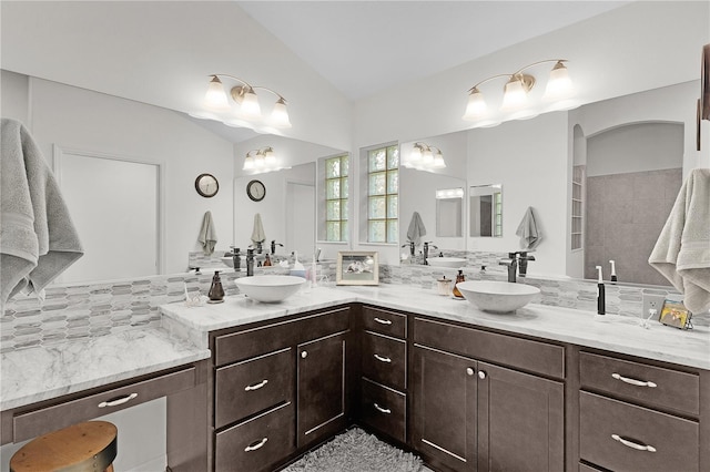 924 Figwood Loop, The Villages, FL 32163 - full bath with lofted ceiling, double vanity, and tasteful backsplash
