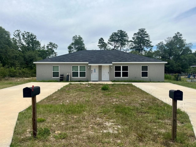 16221 SW 29th Court Rd, Ocala, FL 34473 - single story home featuring concrete driveway, a front lawn, and stucco siding