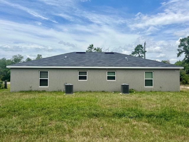 16221 SW 29th Court Rd, Ocala, FL 34473 - back of house featuring stucco siding, cooling unit, and a shingled roof