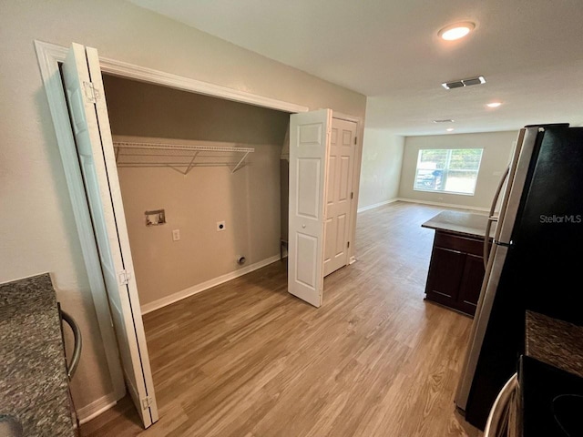 16221 SW 29th Court Rd, Ocala, FL 34473 - laundry room featuring hookup for a washing machine, electric dryer hookup, light wood finished floors, and baseboards