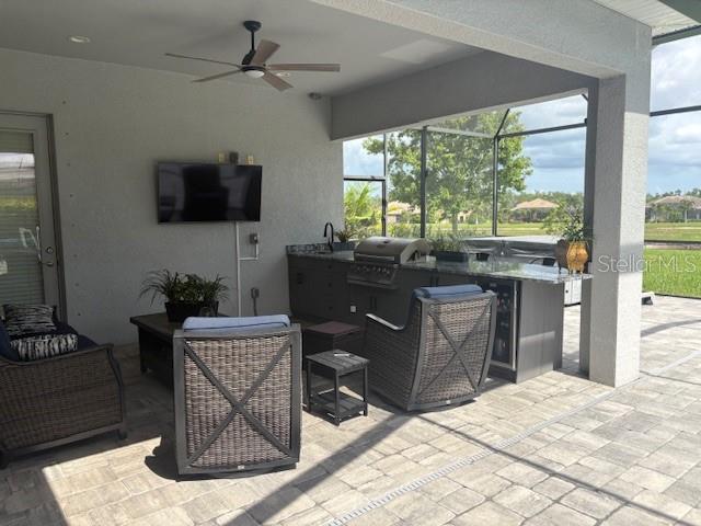 16617 5th Ave E, Bradenton, FL 34212 - view of patio / terrace featuring an outdoor kitchen, a lanai, ceiling fan, and outdoor lounge area