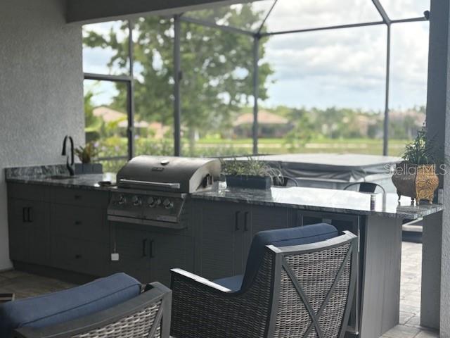 16617 5th Ave E, Bradenton, FL 34212 - view of patio with exterior kitchen and glass enclosure