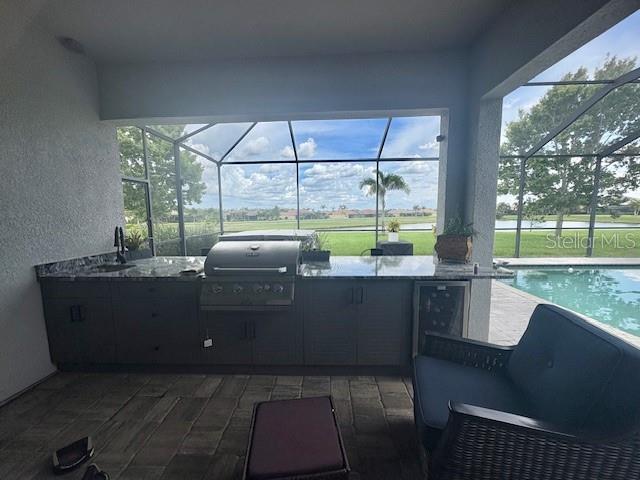 16617 5th Ave E, Bradenton, FL 34212 - view of patio featuring area for grilling, a lanai, and an outdoor pool
