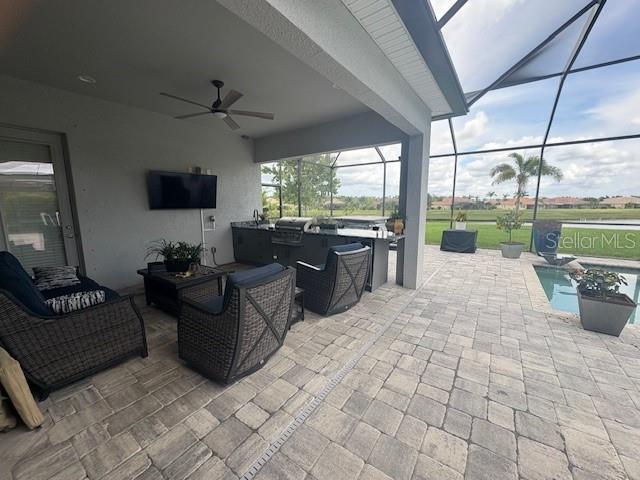 16617 5th Ave E, Bradenton, FL 34212 - view of patio with ceiling fan, an outdoor pool, a lanai, an outdoor hangout area, and area for grilling