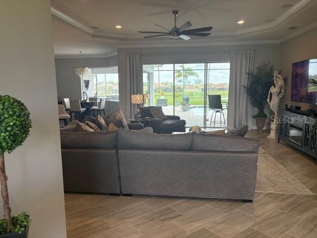 16617 5th Ave E, Bradenton, FL 34212 - living area with a ceiling fan, a raised ceiling, and crown molding