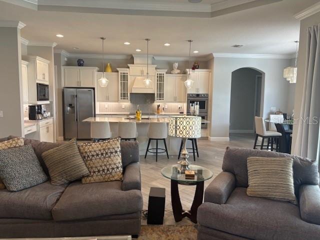 16617 5th Ave E, Bradenton, FL 34212 - living area featuring arched walkways, light wood-style floors, recessed lighting, and crown molding