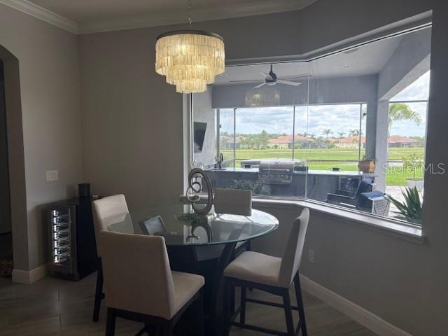 16617 5th Ave E, Bradenton, FL 34212 - dining room with wine cooler, a ceiling fan, arched walkways, and crown molding