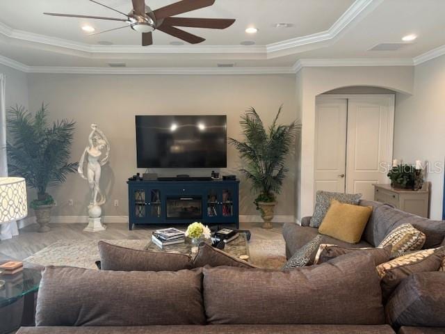 16617 5th Ave E, Bradenton, FL 34212 - living area featuring arched walkways, ceiling fan, a tray ceiling, and ornamental molding