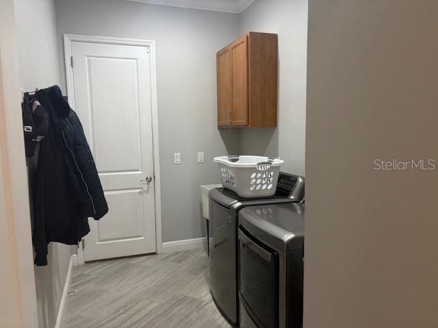 16617 5th Ave E, Bradenton, FL 34212 - washroom with cabinet space, independent washer and dryer, light wood finished floors, and ornamental molding