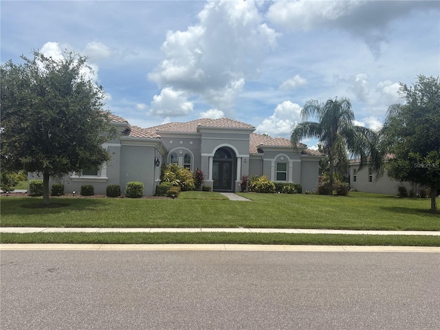 16617 5th Ave E, Bradenton, FL 34212 - mediterranean / spanish-style home featuring a tile roof, a front lawn, stucco siding, and french doors