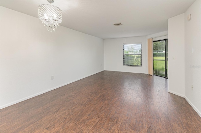 7863 Sugar Bend Dr Unit 7863, Orlando, FL 32819 - spare room with wood finished floors, a chandelier, and baseboards