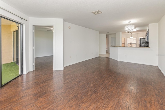 7863 Sugar Bend Dr Unit 7863, Orlando, FL 32819 - unfurnished living room with wood finished floors, a chandelier, a sink, and baseboards