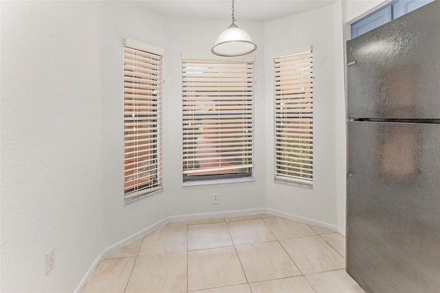 7863 Sugar Bend Dr Unit 7863, Orlando, FL 32819 - unfurnished dining area with tile patterned floors and baseboards