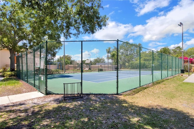 7863 Sugar Bend Dr Unit 7863, Orlando, FL 32819 - view of tennis court with a gate
