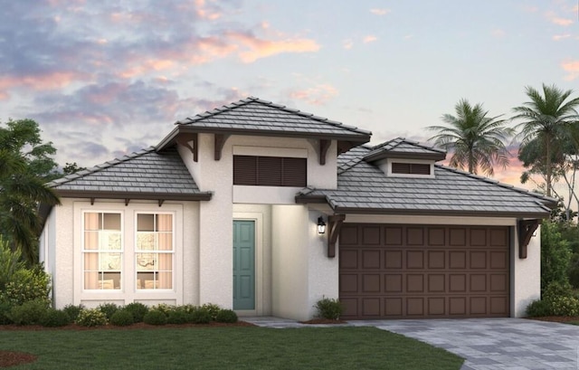 200 Vistera Blvd, North Venice, FL 34275 - view of front of property featuring stucco siding, a garage, driveway, and a front lawn