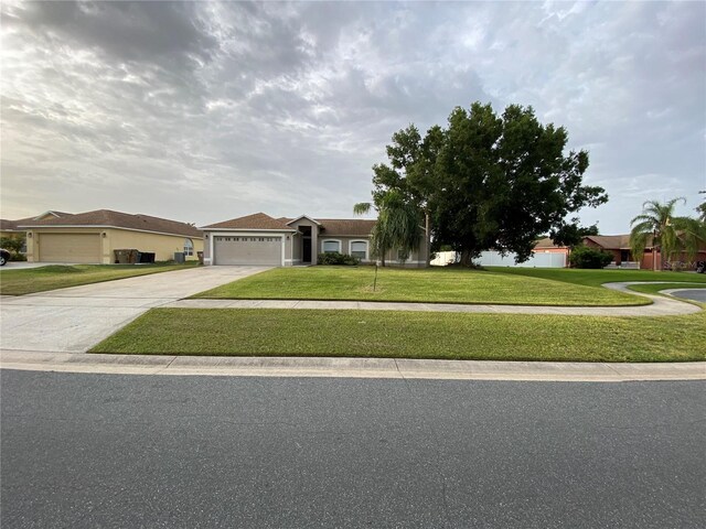 2470 Augusta Way, Kissimmee, FL 34746 - view of front of house with concrete driveway, a front lawn, and a garage