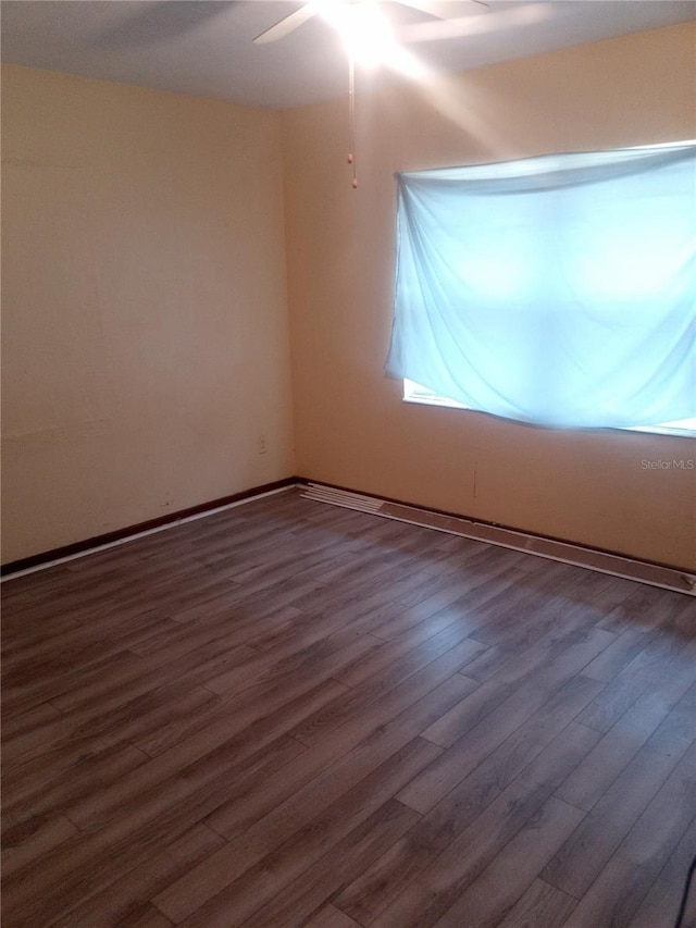 2822 S Dean Rd, Orlando, FL 32825 - unfurnished room with wood finished floors, a ceiling fan, and baseboards