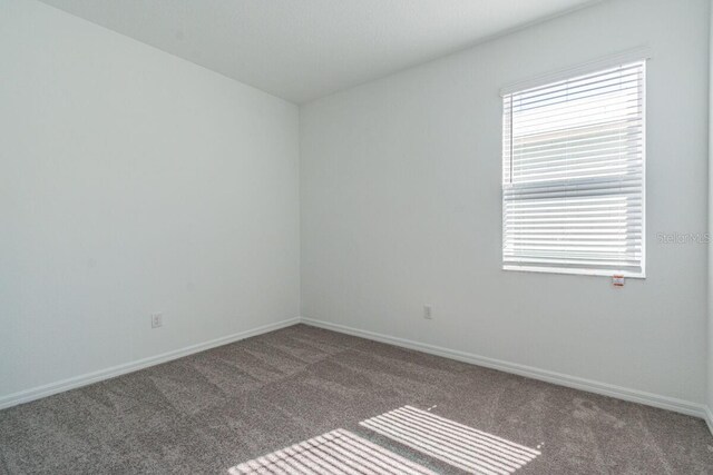 16866 Fiesta Dr, Port Charlotte, FL 33953 - empty room with carpet and baseboards