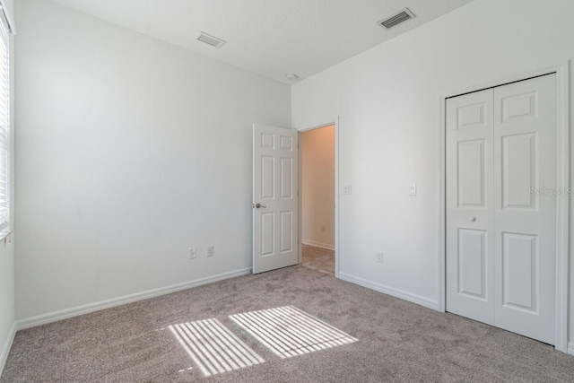 16866 Fiesta Dr, Port Charlotte, FL 33953 - unfurnished bedroom featuring carpet floors and a closet