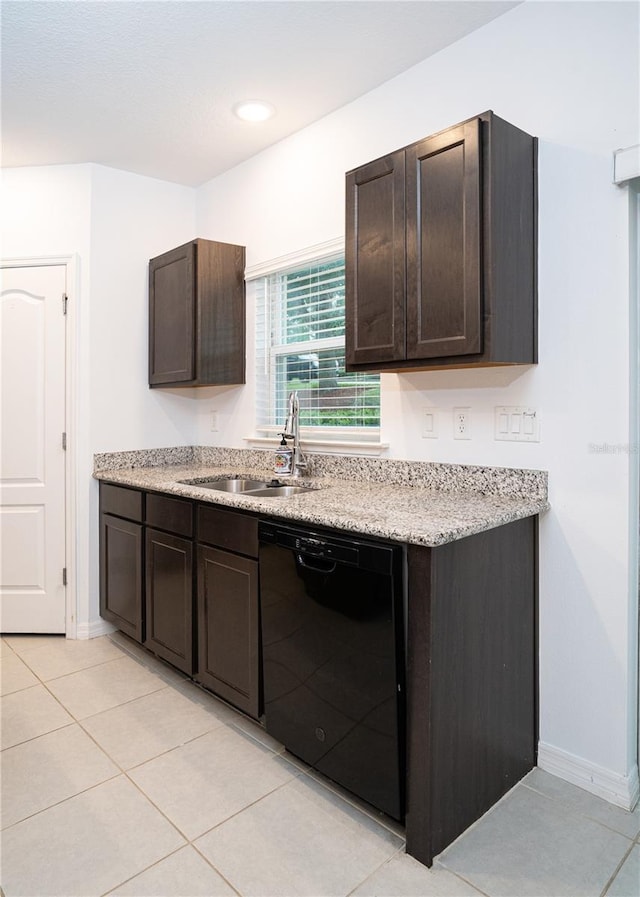 3850 Hampstead Ln, Lakeland, FL 33810 - kitchen with black dishwasher, dark brown cabinets, light tile patterned floors, and light stone countertops