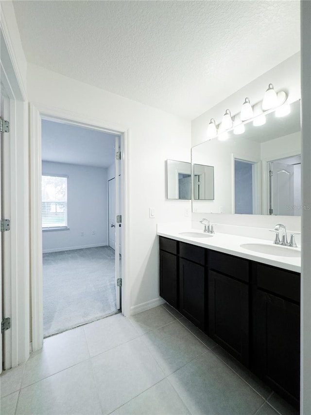 3850 Hampstead Ln, Lakeland, FL 33810 - full bathroom featuring double vanity, a textured ceiling, and tile patterned floors