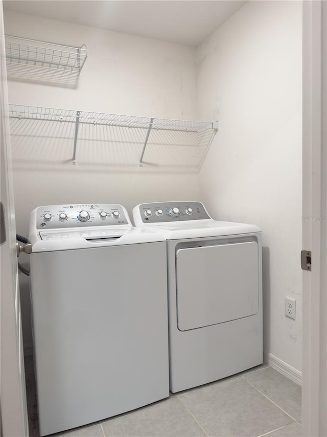 3850 Hampstead Ln, Lakeland, FL 33810 - laundry area featuring separate washer and dryer and light tile patterned flooring