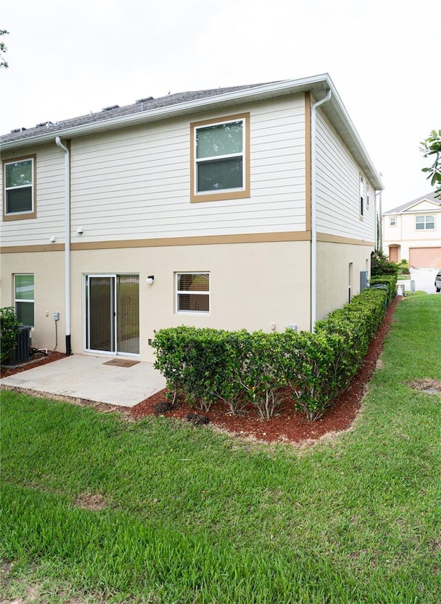3850 Hampstead Ln, Lakeland, FL 33810 - back of house with a yard, a patio, and stucco siding