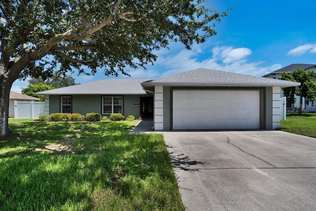 130 Evergreen Dr, Auburndale, FL 33823 - single story home with stucco siding, driveway, and a garage