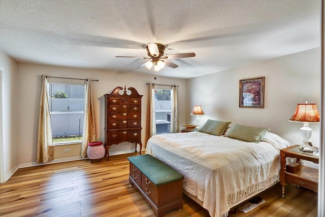 130 Evergreen Dr, Auburndale, FL 33823 - bedroom with light wood-type flooring, a textured ceiling, and a ceiling fan