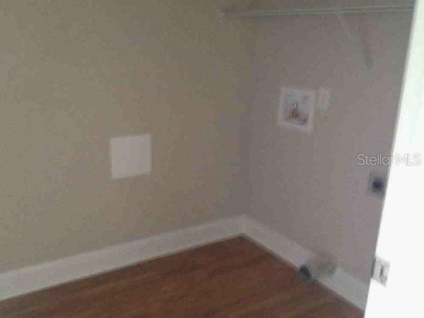 301 NW 8th St, Gainesville, FL 32601 - laundry room featuring wood finished floors and baseboards