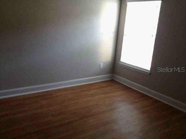 301 NW 8th St, Gainesville, FL 32601 - spare room featuring baseboards and wood finished floors