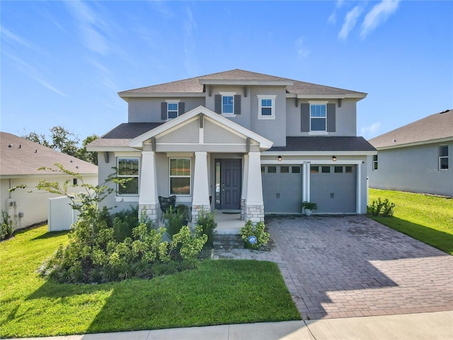 2044 Keystone Pass Blvd, Minneola, FL 34715 - view of front of property featuring stucco siding, a garage, decorative driveway, roof with shingles, and a front yard