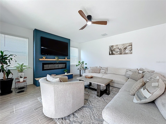 2044 Keystone Pass Blvd, Minneola, FL 34715 - living area with ceiling fan, wood finish floors, and a large fireplace