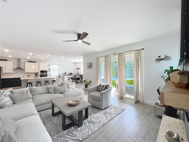 2044 Keystone Pass Blvd, Minneola, FL 34715 - living area with healthy amount of natural light, ceiling fan, recessed lighting, light wood finished floors, and a chandelier