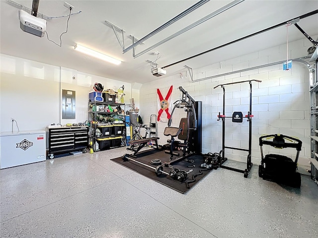 2044 Keystone Pass Blvd, Minneola, FL 34715 - exercise room featuring a garage, electric panel, and concrete block wall