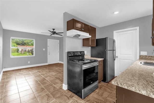 5390 Botany Ct, Orlando, FL 32811 - kitchen with black range with electric cooktop, under cabinet range hood, and light countertops