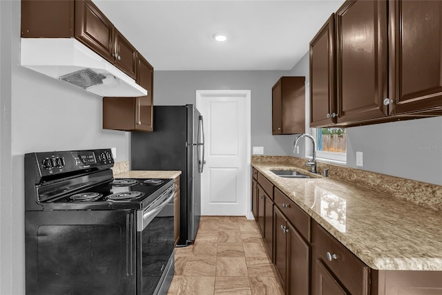 5390 Botany Ct, Orlando, FL 32811 - kitchen featuring black range with electric stovetop, under cabinet range hood, dark brown cabinets, and light stone countertops