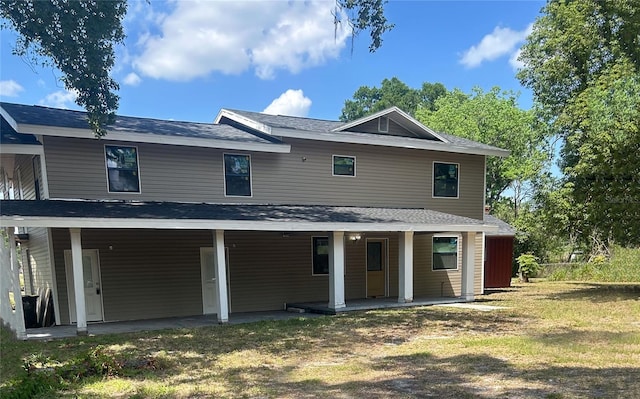2921 Crutchfield Rd W, Lakeland, FL 33805 - rear view of house featuring a lawn
