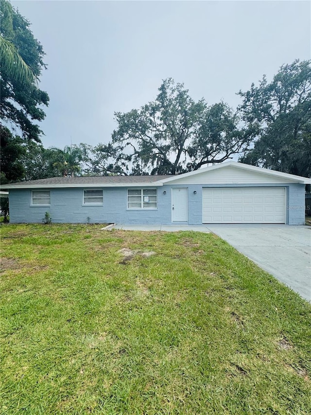 4934 Avery Rd, New Port Richey, FL 34652 - ranch-style house with a garage, driveway, and a front yard