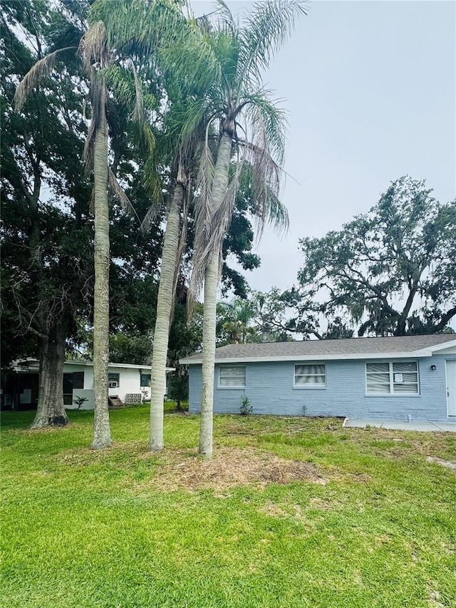 4934 Avery Rd, New Port Richey, FL 34652 - view of side of property with concrete block siding and a lawn