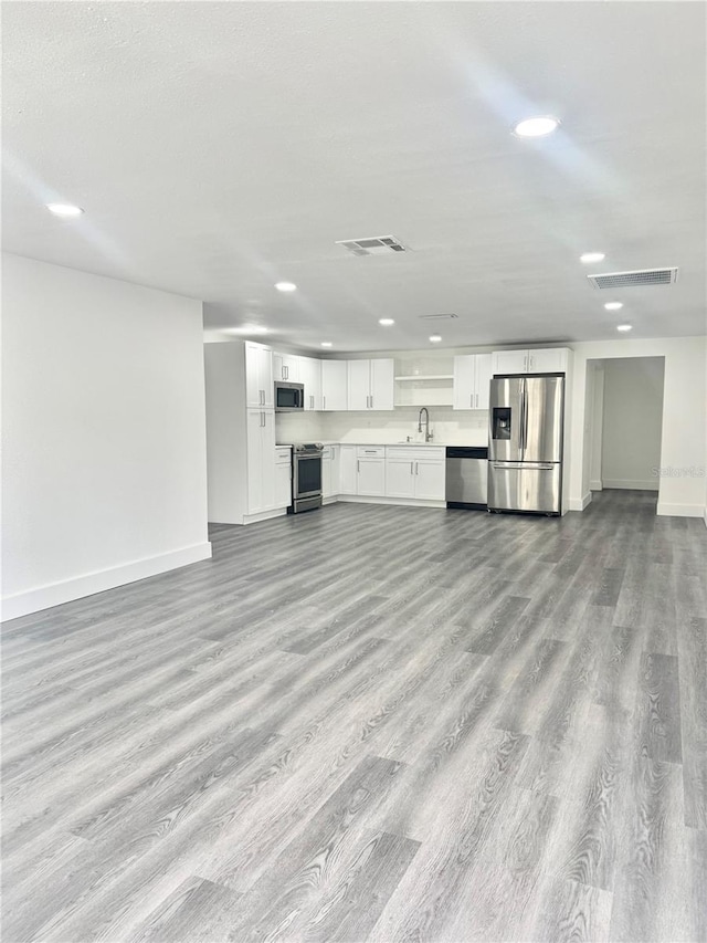 4934 Avery Rd, New Port Richey, FL 34652 - unfurnished living room featuring recessed lighting and wood finished floors