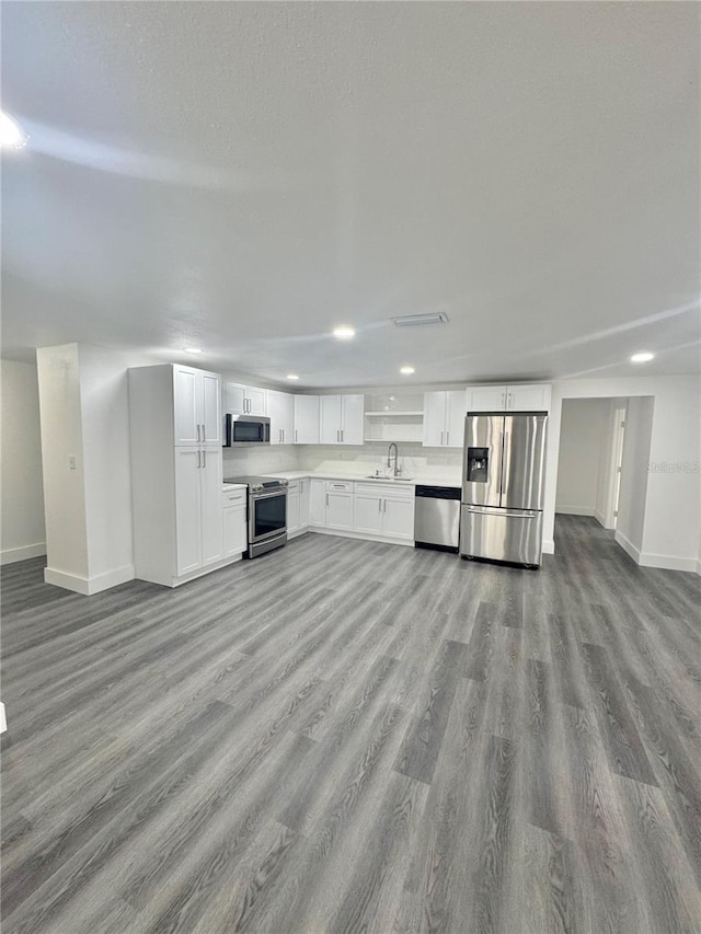 4934 Avery Rd, New Port Richey, FL 34652 - unfurnished living room with wood finished floors and recessed lighting