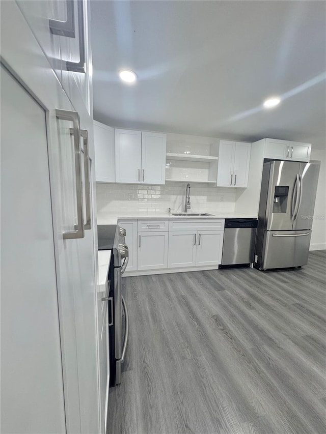 4934 Avery Rd, New Port Richey, FL 34652 - kitchen featuring stainless steel appliances, white cabinets, open shelves, and wood finished floors