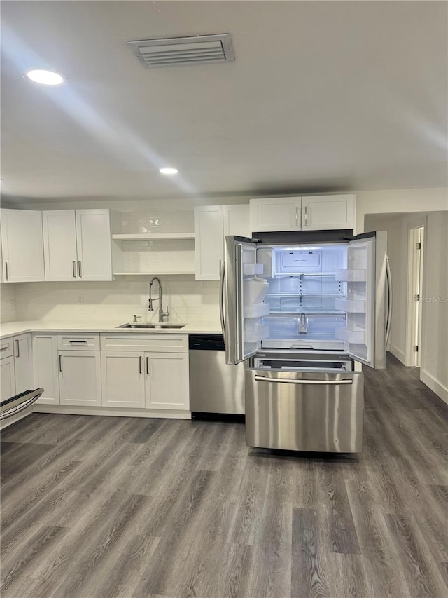 4934 Avery Rd, New Port Richey, FL 34652 - kitchen featuring dishwasher, dark wood-style flooring, white cabinets, and recessed lighting