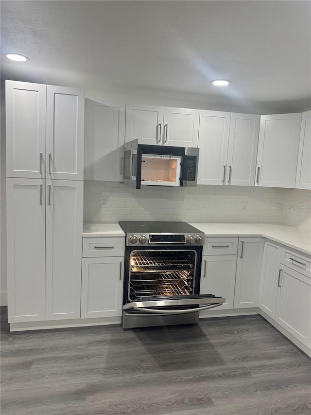 4934 Avery Rd, New Port Richey, FL 34652 - kitchen with stainless steel electric range, white cabinets, light countertops, and recessed lighting