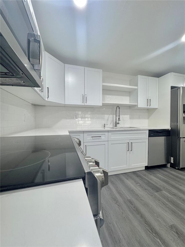 4934 Avery Rd, New Port Richey, FL 34652 - kitchen featuring appliances with stainless steel finishes, open shelves, white cabinets, and decorative backsplash