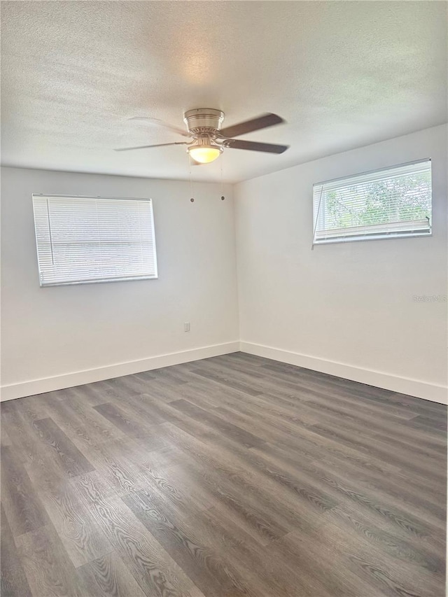4934 Avery Rd, New Port Richey, FL 34652 - empty room featuring a textured ceiling, dark wood-style floors, and ceiling fan