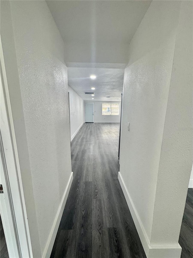 4934 Avery Rd, New Port Richey, FL 34652 - corridor featuring dark wood-type flooring and a textured wall