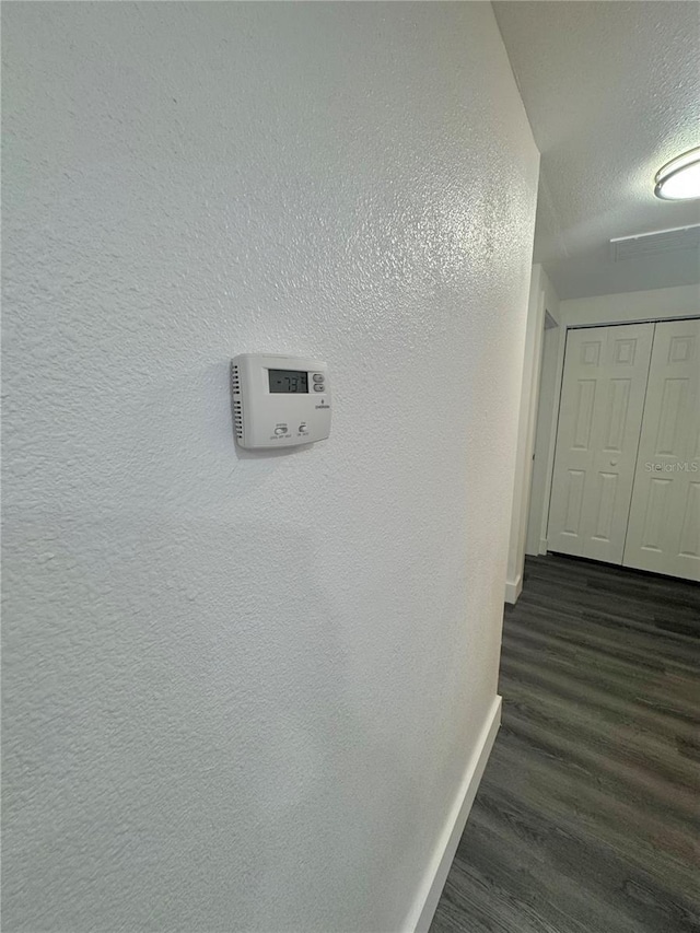 4934 Avery Rd, New Port Richey, FL 34652 - hallway featuring a textured ceiling and dark wood-style flooring